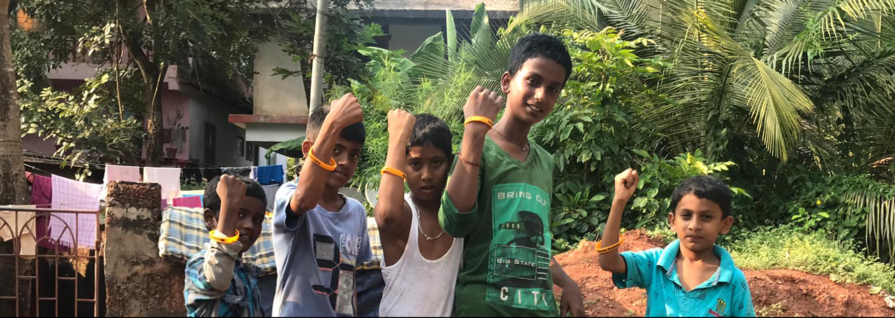 Children show off their armband to prove their dogs were vaccinated against rabies.